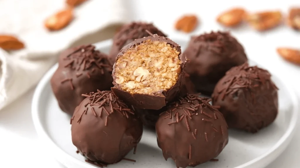 Close-up of delicious homemade pecan pie balls on a plate, perfect for a sweet treat.